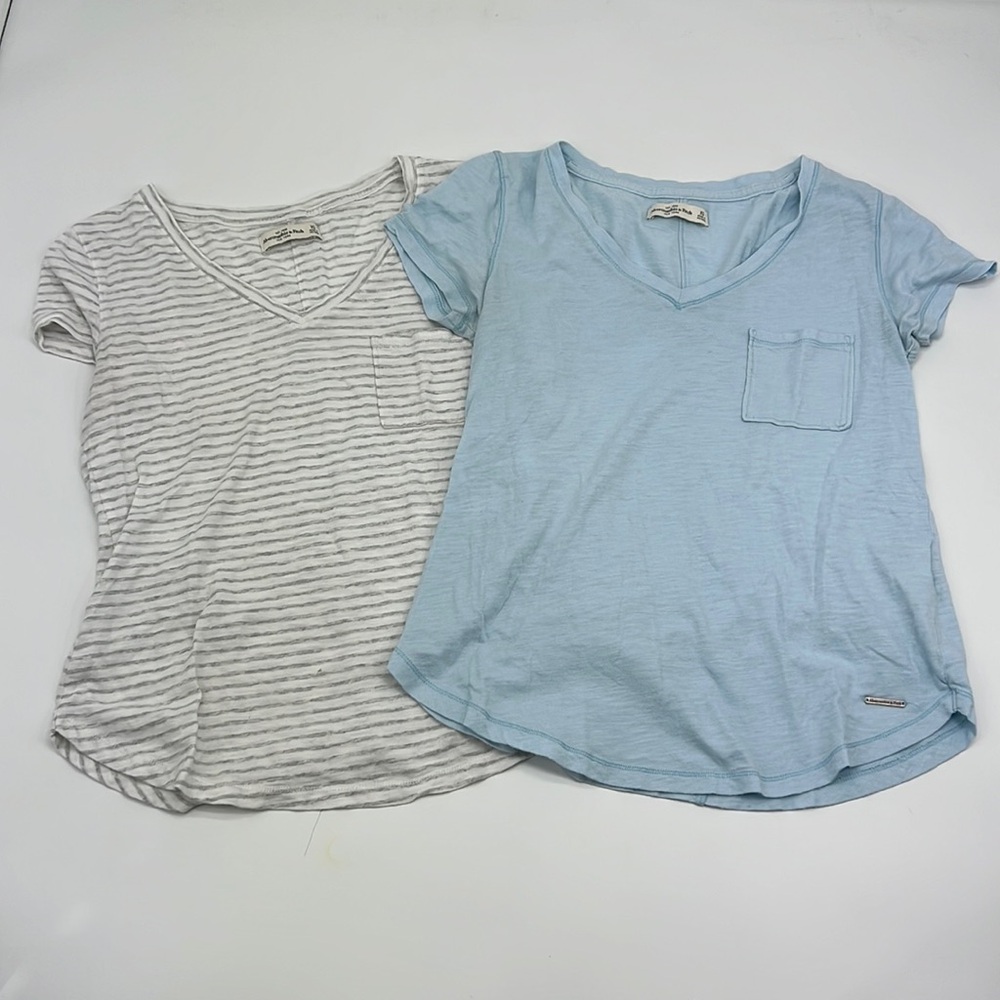 New White and Grey strips and light Blue T-Shirts.
